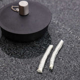 Two spare wicks for SACKit oil lamp, thin and white, displayed on a plain background.