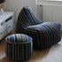 Flerfarget Lounge Chair Paul Smith i bomull med lineært design, moderne dansk stil, satt i lyst rom.
