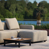 Cobana Lounge Sofa pouf in black with aluminum frame and outdoor fabric, shown in a minimalist setting.