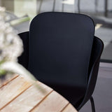 Taupe Patio Chair no. One S2 with black frame made of recycled plastic and steel, outdoor setting.