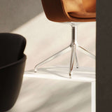 Chair no. One S2 Terra Black with polished aluminum swivel base in a simple indoor setting.