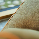 SACKit Chair Indoor i rund, myk form med grønt Cosmo Olive stoff og lav sittehøyde.