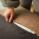 Nærbilde av mykt brunt sofatrekk med åpen glidelås som viser polstringen og det sorte stoffet på undersiden fra sackit sofa innendørs