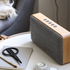 Bluetooth-høyttaler i naturlig eik med Fiord-tekstil fra KVADRAT og messingdetaljer.
