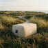 Soft Sofa Outdoor pouf i boucle beige stoff med myk, rund form for utebruk.