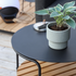 Rundt utendørs sofabord i sort pulverlakkert aluminium med teak bordplate, dansk design.