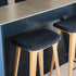 Nordic Bar Stool in oak with Luna Carbon leather seat and powder-coated steel footrest.