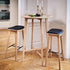Nordic Bar Stool in Terra Black leather with oak frame and visible stitches, 73 cm high.