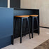 Nordic Bar Stool in black stained oak with Terra Black leather seat and steel footrest.