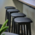 Nordic Bar Stool in black stained oak with Terra Black leather seat and steel footrest.