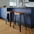 Nordic Bar Stool in black stained oak with Terra Black leather seat and steel footrest.
