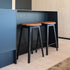Nordic Bar Stool i svartbeiset eik med Terra Black skinn og mørke sømmer, høyde 73 cm.