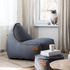 Canvas Lounge Chair og pouf i petrol lerretstoff med myk, rund form og ryggstøtte, innendørs bruk.