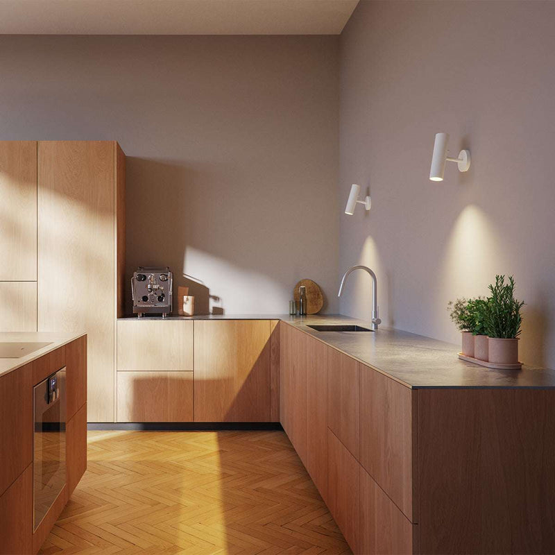 Hvit Expo Wall vegglampe i aluminium med enkel, rund form og berøringsknapp.