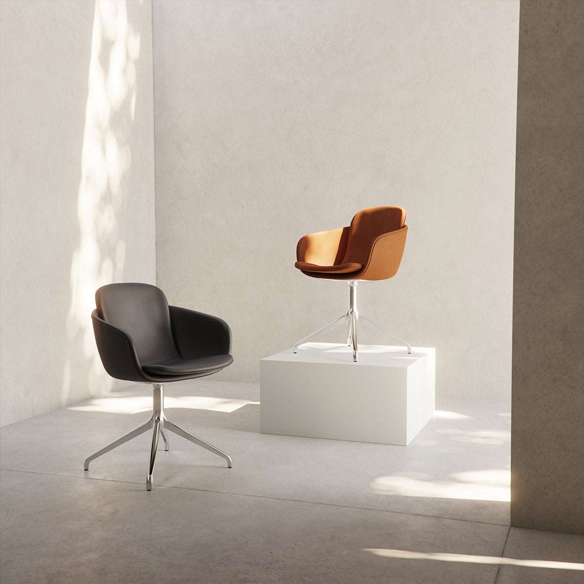 Chair no. One S2 Terra Black with polished aluminum swivel base in a minimalist indoor dining setting.
