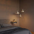 Polished Dawn Pendant Ø25 pendant light with perforated top and white inner shade hanging indoors