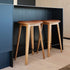 Nordic Bar Stool in oak with black Terra leather and matching dark stitches, modern bar chair design.