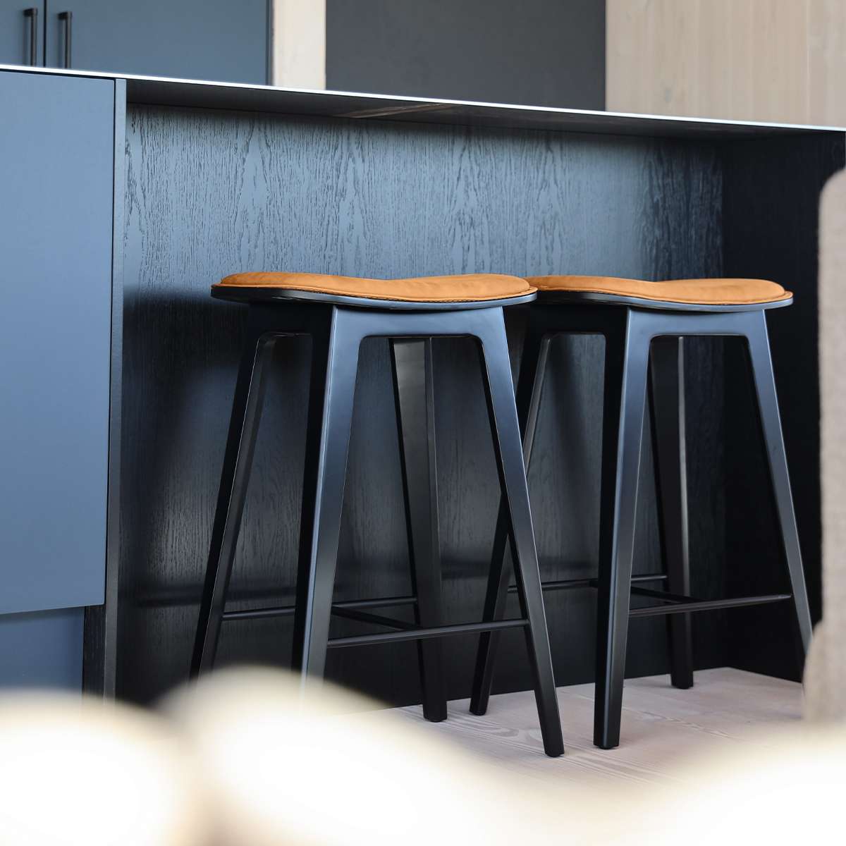 Nordic Bar Stool in black stained oak with Terra Black leather and matching dark stitches.