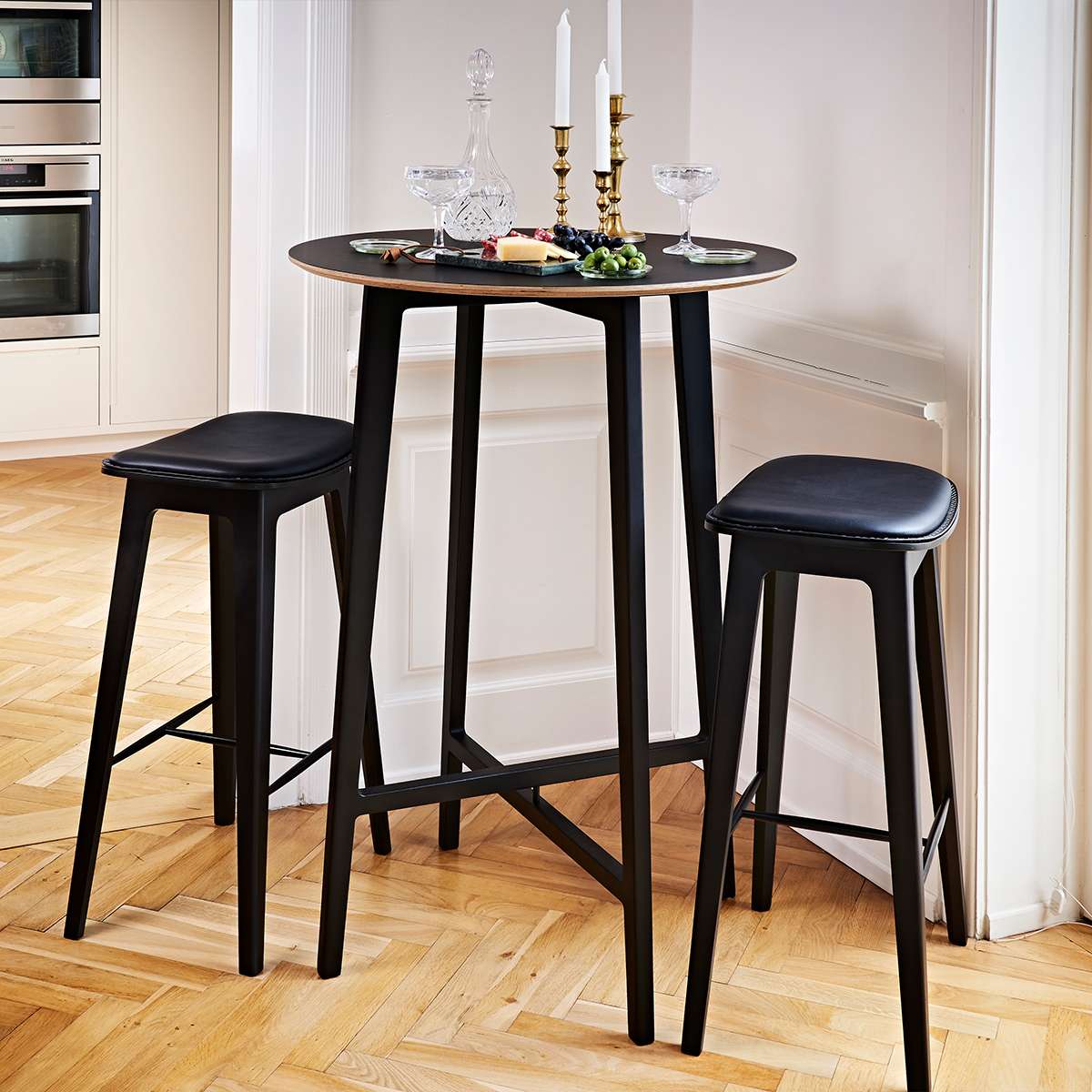 Nordic Bar Stool in black stained oak with Terra Black leather and matching dark stitches.