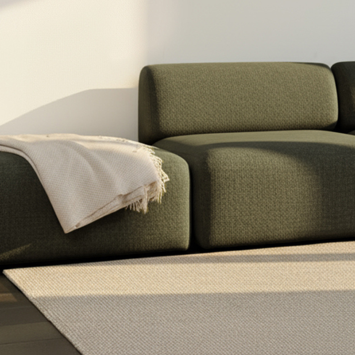 Fjord Sofa pouf i myk, olivengrønn tekstil med rundet form og skandinavisk design.