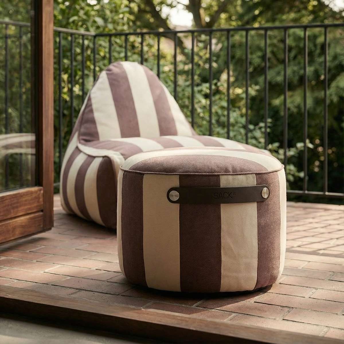 sackit utendørs puff i brune og kremfargede striper på en terrasse sammen med matchende loungestol i nordisk design